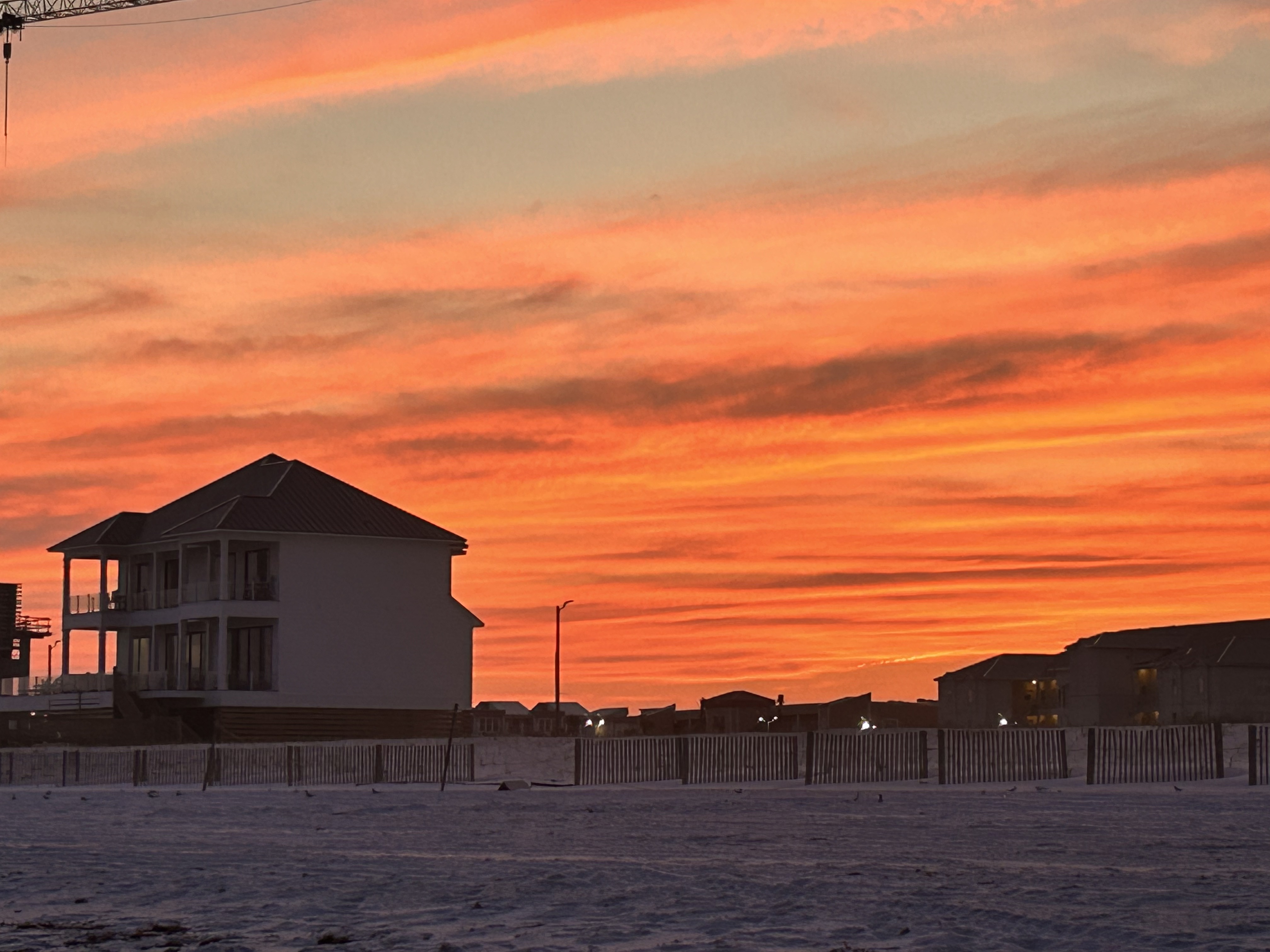 Image of house at sunset from beach
